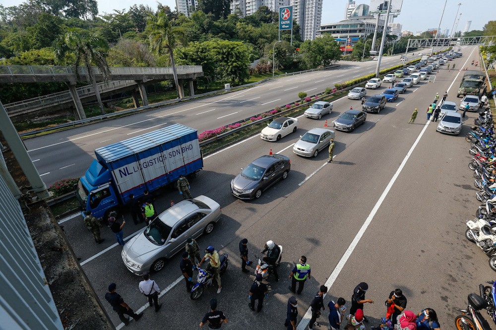 Several Malaysian Armed Forces personnel are seen assisting the police at one of the roadblocks to help maintain the movement control order at Tun Dr Lim Choong Eu Highway in Penang March 22, 2020. u00e2u20acu201d Picture by Sayuti Zainudin