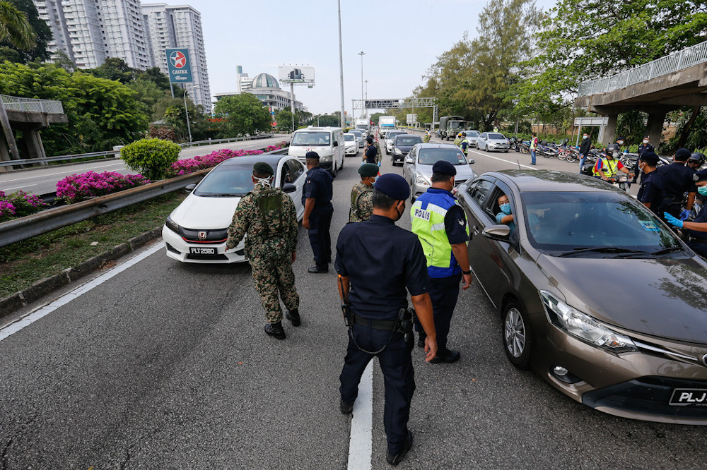 Several Malaysian Armed Forces personnel are seen assisting the police at one of the roadblocks to help maintain the movement control order at Tun Dr Lim Choong Eu Highway in Penang March 22, 2020. u00e2u20acu201d Picture by Sayuti Zainudin