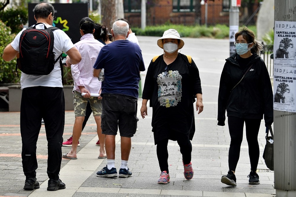 People wait in a queue to receive benefit payouts, including unemployment and small business support as the novel coronavirus inflicts a toll on the economy, at a Centerlink payment centre in downtown Sydney March 27, 2020. u00e2u20acu201d AFP pic