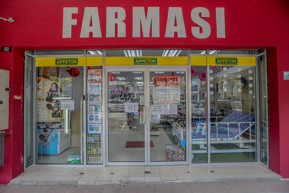 A sign announcing that face masks are sold out is seen at a pharmacy in Cheras March 22, 2020. u00e2u20acu201d Picture by Firdaus Latif 