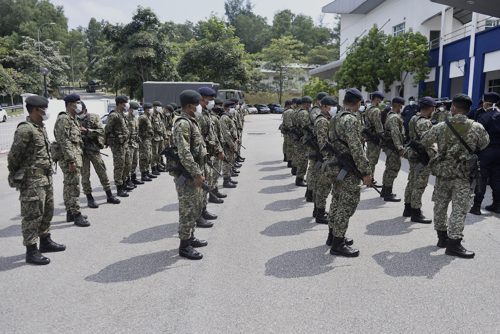 Army personnel from Regimen 502 Askar Wataniah, Kem Sungai Buloh arrive at IPD Shah Alam to assist the police in enforcing the movement control order (MCO), March 22, 2020. u00e2u20acu201d Picture by Miera Zulyana