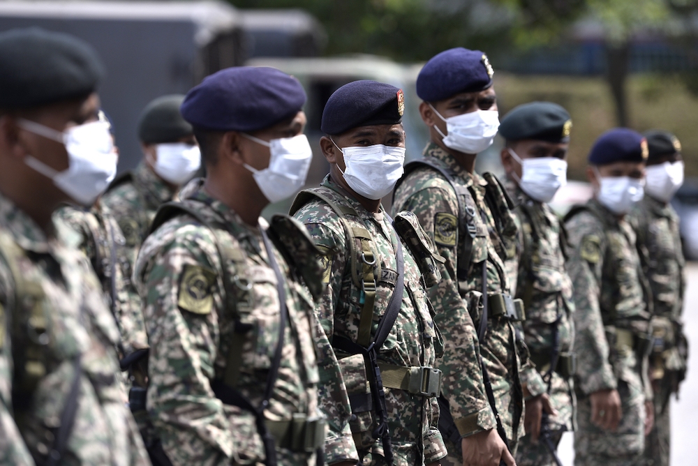 Army personnel from Regimen 502 Askar Wataniah, Kem Sungai Buloh arrive at IPD Shah Alam to assist the police in enforcing the movement control order (MCO), March 22, 2020. u00e2u20acu201d Picture by Miera Zulyana