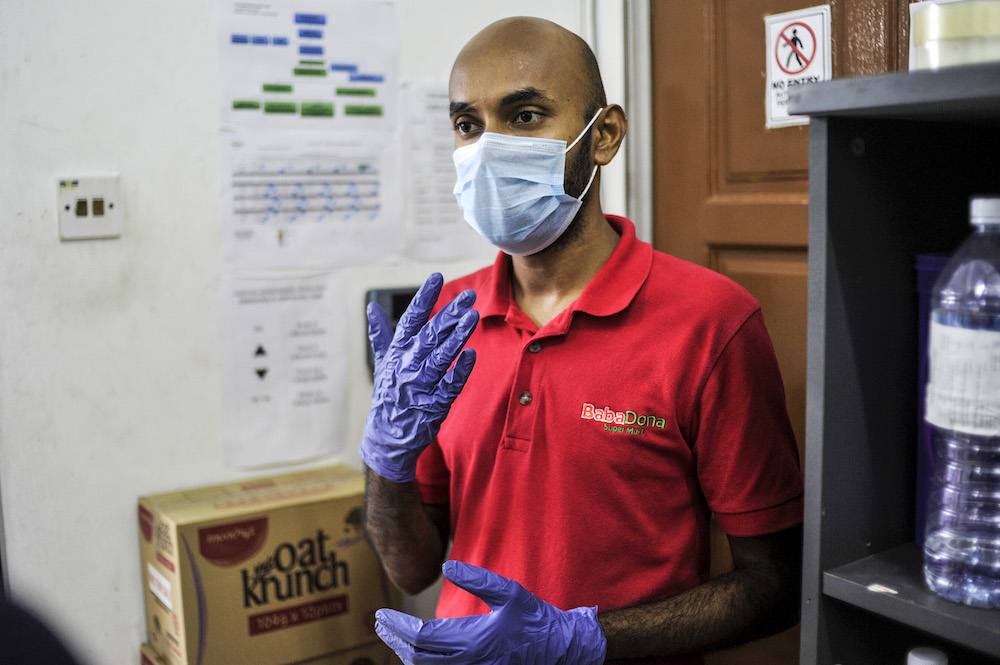 Baba Dona Super Mart Lembah Pantai floor manager Mohamad Faris Abdullah speaks to Malay Mail during the observation of precautionary measures to curb the spread of Covid-19 in Kuala Lumpur, March 22, 2020. — Picture by Shafwan Zaidon