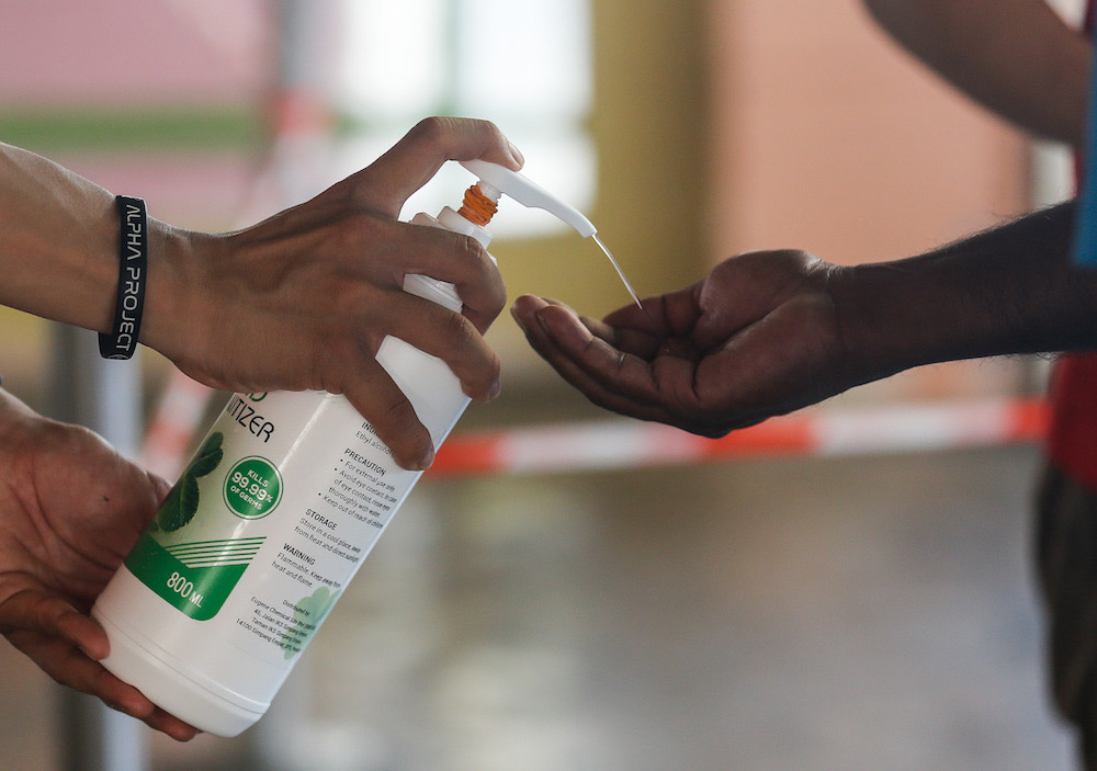 Members of the public are seen getting their hands sanitised at Tanjung Bungah wet market, March 22, 2020. Picture by Sayuti Zainudin