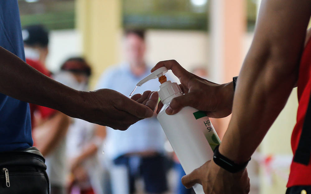 Members of the public are seen getting their hands sanitised at Tanjung Bungah wet market, March 22, 2020. Picture by Sayuti Zainudin