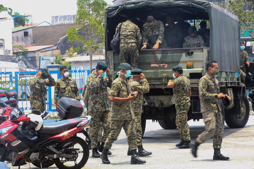 Army trucks are seen entering the compound of the Northeast District Police Station for a briefing session in George Town March 22, 2020. u00e2u20acu201d Picture by Sayuti Zainudin