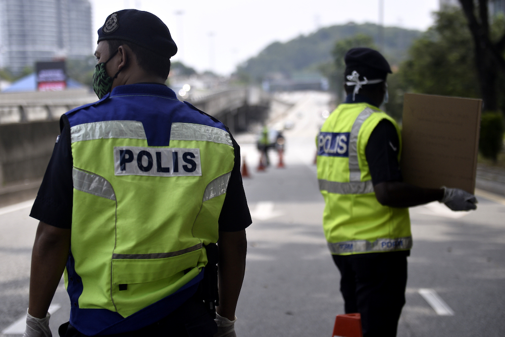 Soldiers and police officers conducting checks at a roadblock on day five of the movement control order (MCO) in Sri Hartamas March 22,2020. u00e2u20acu201d Picture by Miera Zulyana