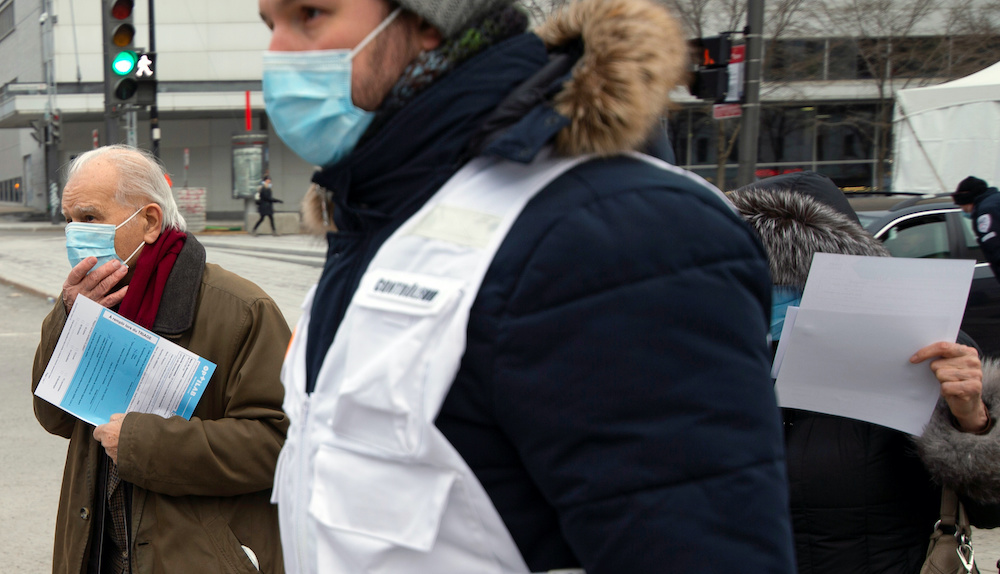 A man is escorted by healthcare workers to be tested as the city's public health unit holds a walk-in clinic testing for coronavirus disease (Covid-19) in Montreal March 23, 2020. u00e2u20acu201d Reuters pic