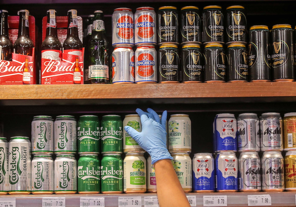 A Jaya Grocer staff arranging cans of beer in Ipoh. Some supermarkets and mini markets saw a shortage in beer supply after a few beer companies shut down their operations following the MCO. u00e2u20acu201d Picture by Farhan Najib