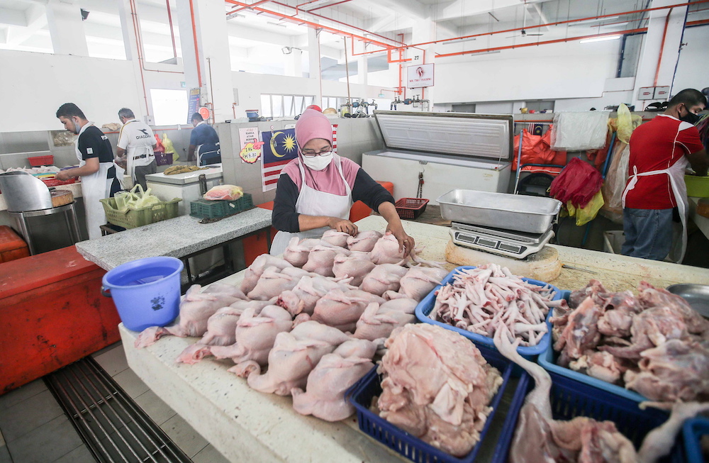 Chicken traders are pictured at the Ipoh Central Market March 25, 2020. u00e2u20acu201d  Picture by Farhan Najib