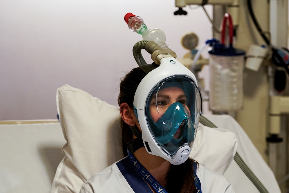 A medical worker tests a Decathlon snorkeling mask upgraded with 3D-printed respiratory valves fittings at the Erasme Hospital in Brussels March 27, 2020. u00e2u20acu201d AFP pic
