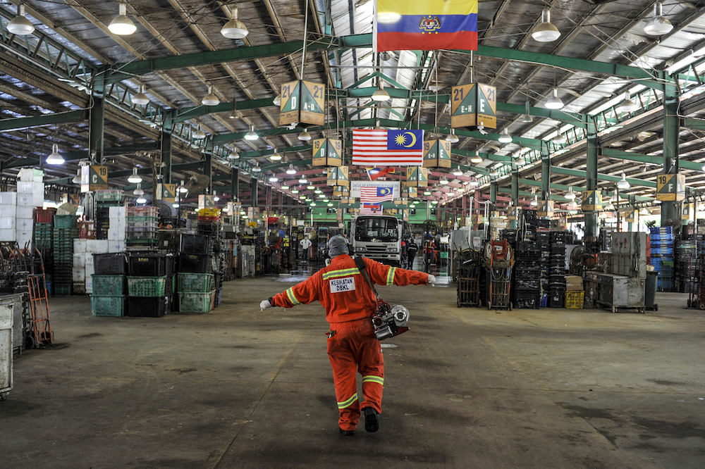 Workers from the local authorityu00e2u20acu2122s health unit spray disinfectant in the Selayang wet market, Kuala Lumpur March 29, 2020. u00e2u20acu201d Picture by Shafwan Zaidon