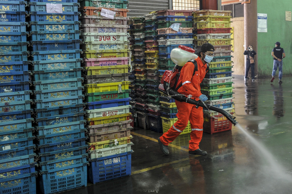 Workers from the local authorityu00e2u20acu2122s health unit spray disinfectant in the Selayang wet market, Kuala Lumpur March 29, 2020. u00e2u20acu201d Picture by Shafwan Zaidon