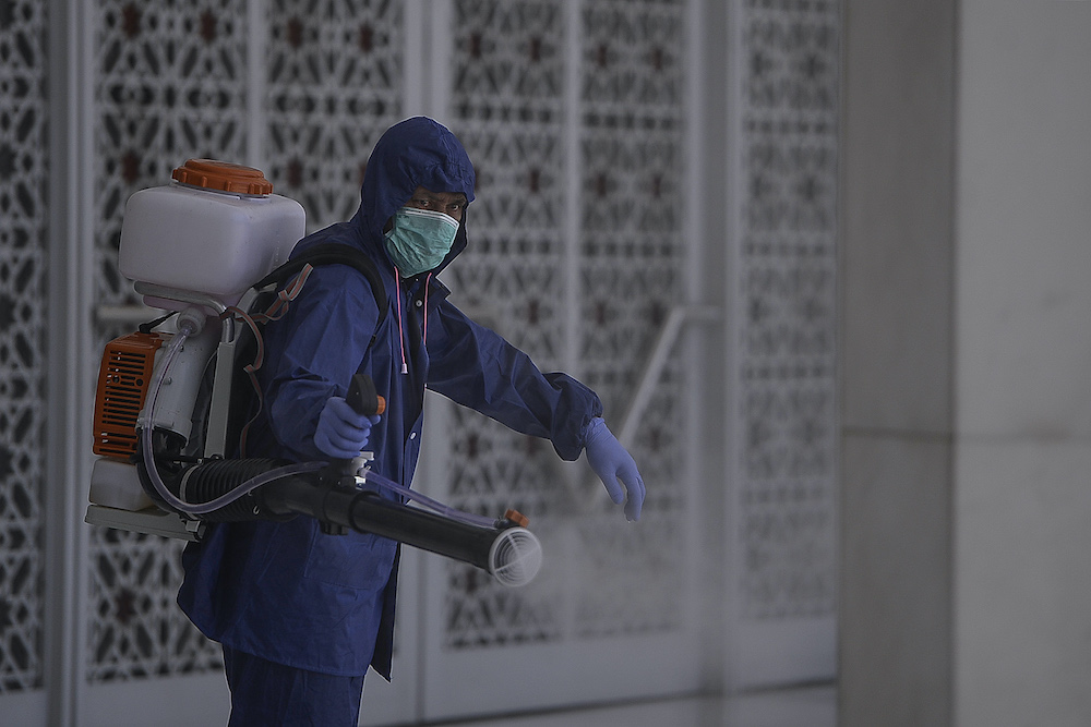 A worker sprays disinfectant in a mosque as a precaution against the spread of Covid-19, Shah Alam March 29, 2020. u00e2u20acu201d Picture by Miera Zulyana