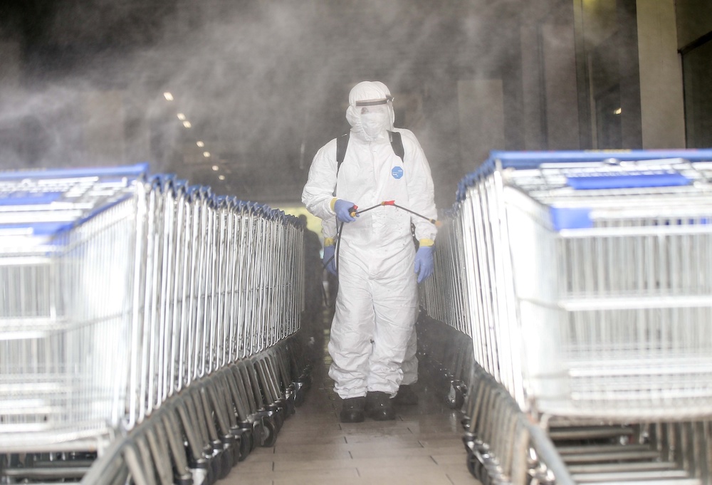 Personnel from the fire department carry out disinfection operations at Mydin Mall in Meru March 30, 2020. u00e2u20acu201d Picture by Farhan Najib