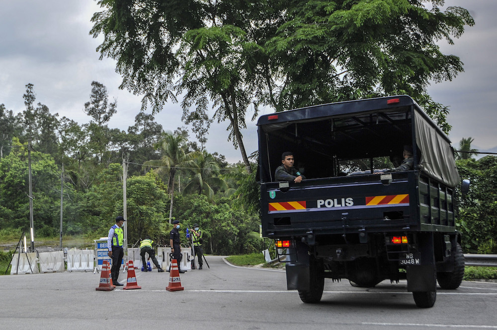 A police truck is seen entering the village during the enhanced movement control order (EMCO) in seven villages in Hulu Langat March 30, 2020. u00e2u20acu201d Picture by Shafwan Zaidon