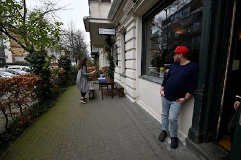 German chef Maximilian Strohe looks on as a woman picks up meals that he prepared for healthcare workers. u00e2u20acu201d AFP-Relaxnews picnn
