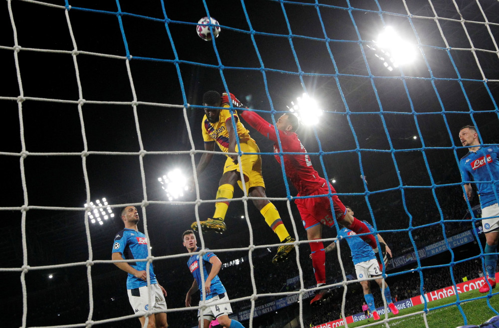 Barcelonau00e2u20acu2122s Junior Firpo in action with Napoliu00e2u20acu2122s David Ospina during the Champions League round of 16 first leg match at Stadio San Paolo, Naples, Italy February 25, 2020. u00e2u20acu201d Reuters pic  