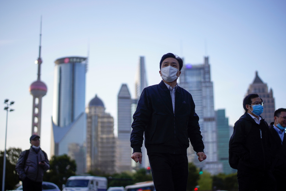 People wear protective face masks, following an outbreak of the novel coronavirus disease at Lujiazui financial district in Shanghai, China March 19, 2020. u00e2u20acu201d Reuters pic 