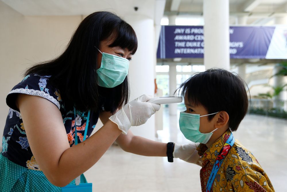 A teacher checks a student with thermal scanner at school after Indonesia confirmed its first cases of coronavirus disease (COVID-19), in Tangerang near Jakarta, Indonesia, March 6, 2020. u00e2u20acu201d Reuters pic