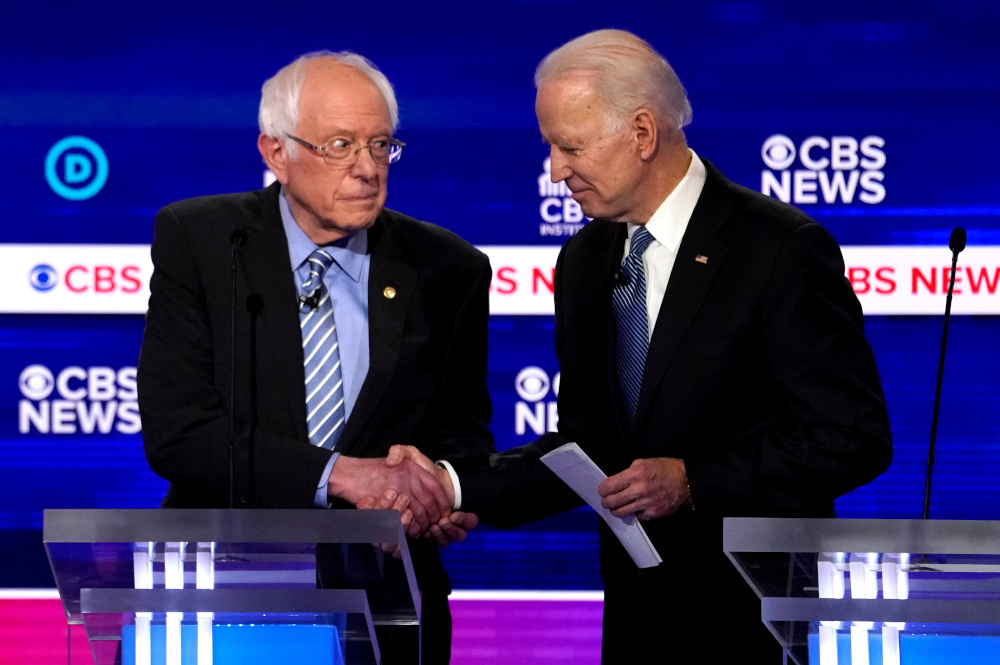 Democratic 2020 US presidential candidates Senator Bernie Sanders shakes hands with former Vice President Joe Biden after the tenth Democratic 2020 presidential debate at the Gaillard Center in Charleston, South Carolina, US February 25, 2020. u00e2u20acu201d Reuters