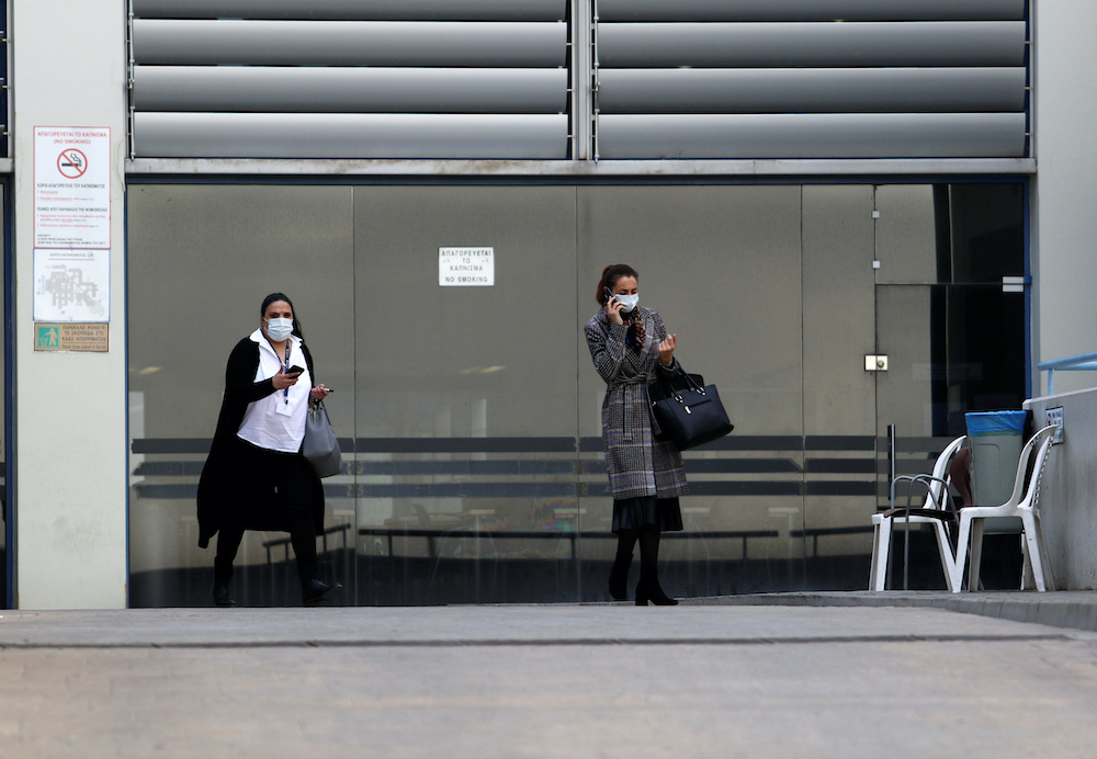 Women wearing masks stand outside Nicosia General hospital, Cyprusu00e2u20acu2122s largest medical facility that suspended admissions on Tuesday after a heart surgeon tested positive for coronavirus, in Nicosia, Cyprus March 10, 2020. u00e2u20acu201d Reuters picnn