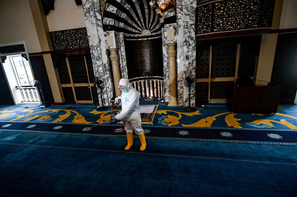 A worker disinfects an area of the Darul Hana mosque at Jalan Tun Salahudin in Kuching March 17, 2020. u00e2u20acu201d Bernama pic