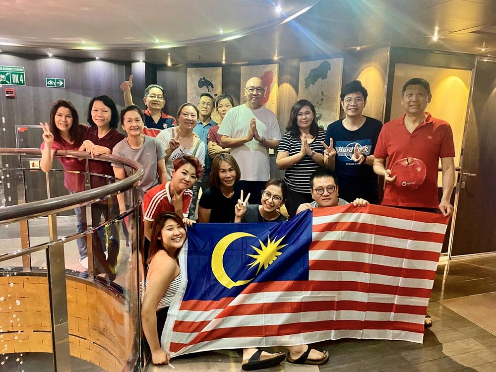The 16 Malaysian tourists on board the Antartica-bound cruiseship, Lu00e2u20acu2122Austral, who were stranded in Brazil are seen in this photo posing with the Jalur Gemilang March 23, 2020. u00e2u20acu201d Bernama pic