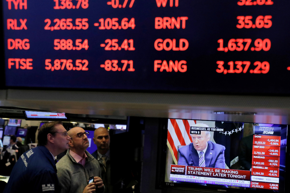 US President Donald Trump is seen on a screen under trading figures during his meeting with bank executives as traders work on the floor of the New York Stock Exchange (NYSE) in New York City, New York, US, March 11, 2020. u00e2u20acu201d Reuters pic 