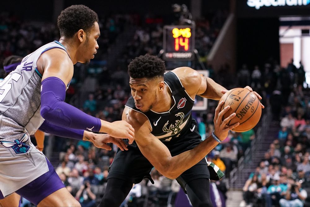 Milwaukee Bucks forward Giannis Antetokounmpo (right) handles the ball against Charlotte Hornets forward PJ Washington during the second half at Spectrum Centre. u00e2u20acu201d Reuters pic