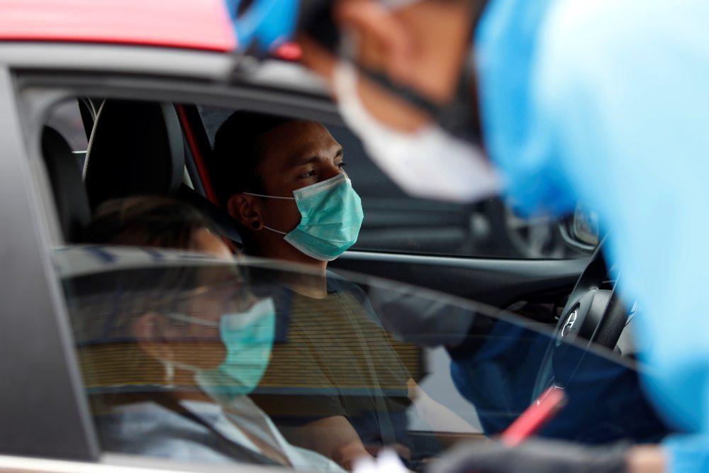 Travellers wear face masks inside a car hours before the Colombian government's mandatory 19-day isolation as a preventive measure against the spread of the coronavirus disease, in Bogota March 23, 2020. u00e2u20acu2022 Reuters pic