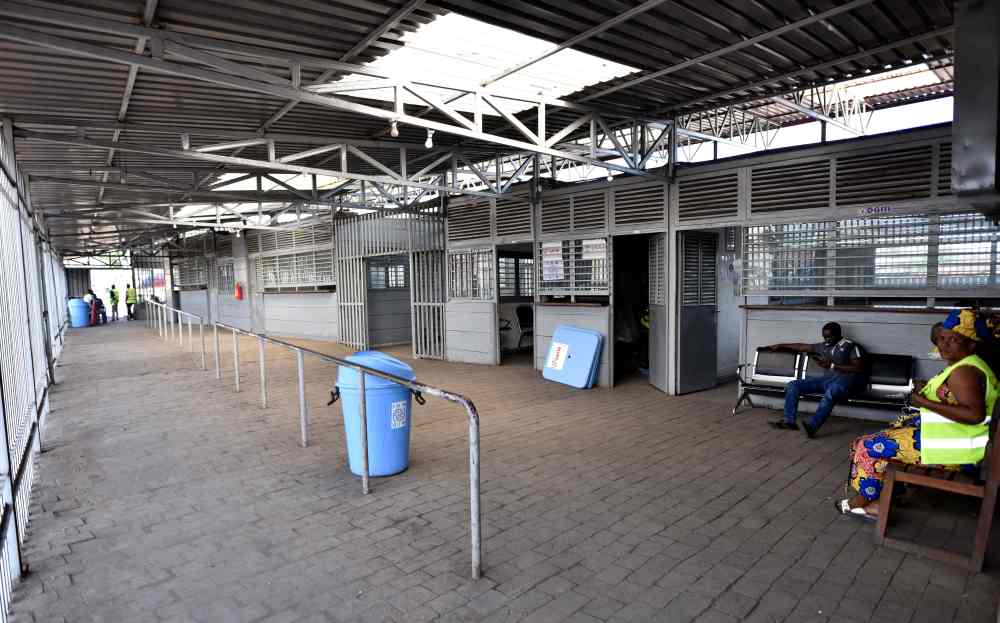 Health and customs officials sit at a deserted crossing point between the Democratic Republic of Congo and Rwanda amid concerns about the spread of coronavirus disease, at the Petite Barriere in Goma, in the Democratic Republic of Congo March 23, 2020. u00e2u20ac
