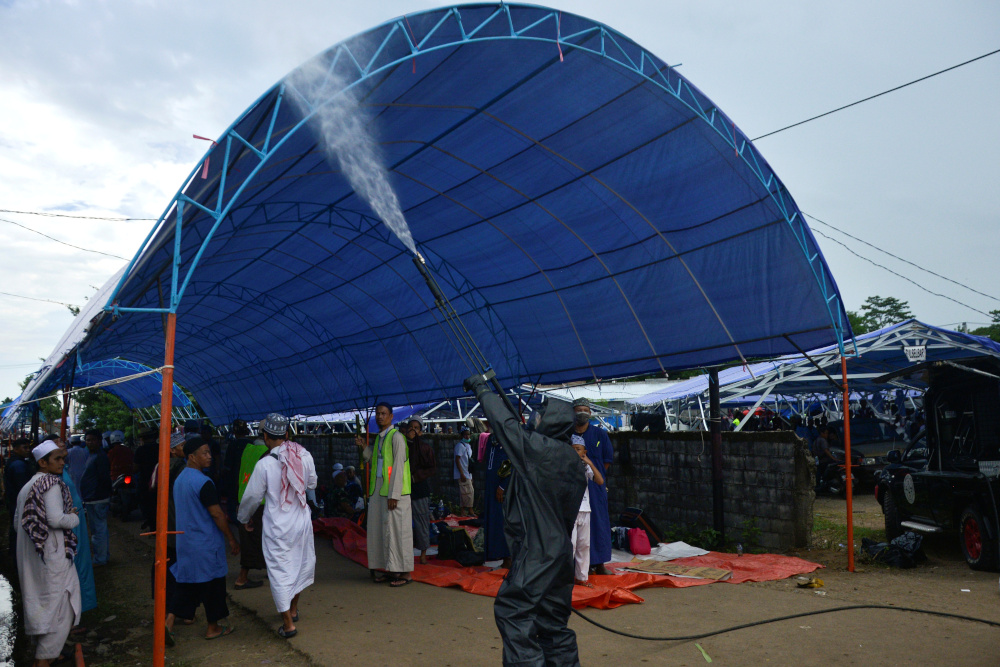 A police officer wearing a protective suit sprays disinfectant on a tent intended for Muslim pilgrims to stay for a mass gathering to be held amid the spread of Covid-19 in Gowa, South Sulawesi province, Indonesia, March 19, 2020. u00e2u20acu201d Reuters pic 