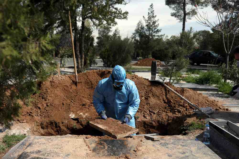 An Iranian man buries the journalist Abdollah Zavieh, who passed away due to coronavirus disease, at Behesht Zahra cemetery in Tehran March 24, 2020. u00e2u20acu2022 Reuters pic