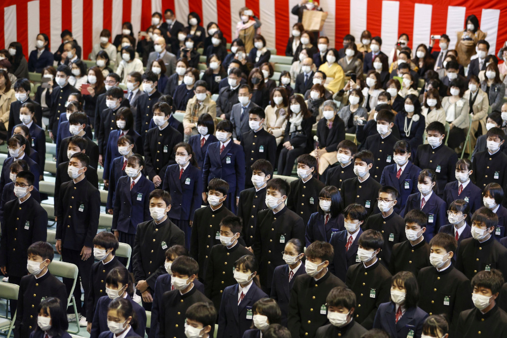 Students wearing protective masks following an outbreak of the coronavirus disease, attend their graduation ceremony at a junior high school in Osaka, western Japan March 13, 2020, in this photo released by Kyodo. u00e2u20acu201d Kyodo handout pic via Reuters 