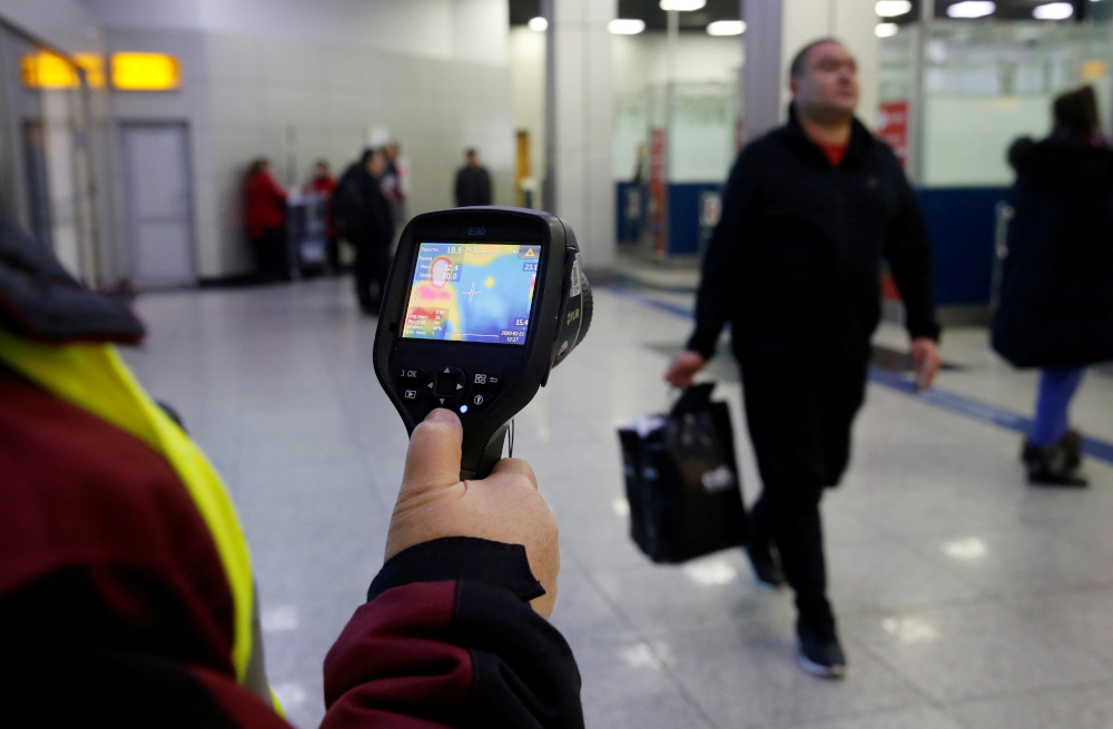 A Kazakh sanitary-epidemiological service worker uses a thermal scanner to detect travellers who may have symptoms possibly connected with the coronavirus at Almaty International Airport, Kazakhstan January 21, 2020. u00e2u20acu201d Reuters pic 