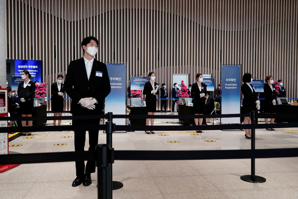 Employees wearing a mask to prevent contracting the coronavirus wait for a shareholder of Samsung Electronics Co before the companyu00e2u20acu2122s annual general meeting in Suwon, South Korea, March 18, 2020. u00e2u20acu201d Reuters pic 