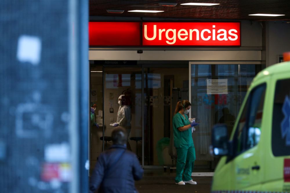 Healthcare workers are pictured at the entrance of the emergency unit at La Paz hospital during the coronavirus disease outbreak in Madrid March 23, 2020. u00e2u20acu2022 Reuters pic
