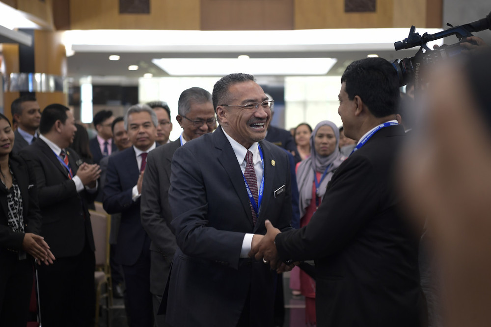 Foreign Minister Datuk Seri Hishammuddin Hussein shakes hands with ministry staff at the ministry in Putrajaya March 11, 2020. u00e2u20acu201d Bernama pic 
