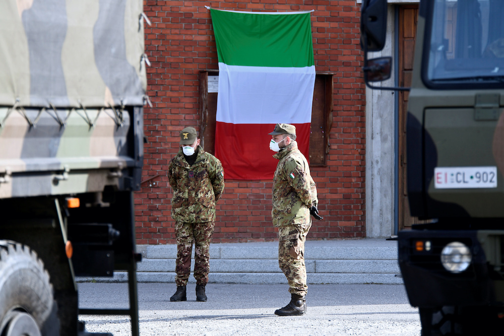 Soldiers wait by the military trucks to take away coffins that have been piling up in a church due to the high number of deaths as Italy struggles to contain a spread of coronavirus disease (Covid-19) in Seriate, Italy March 28, 2020. u00e2u20acu201d Reuters picnn