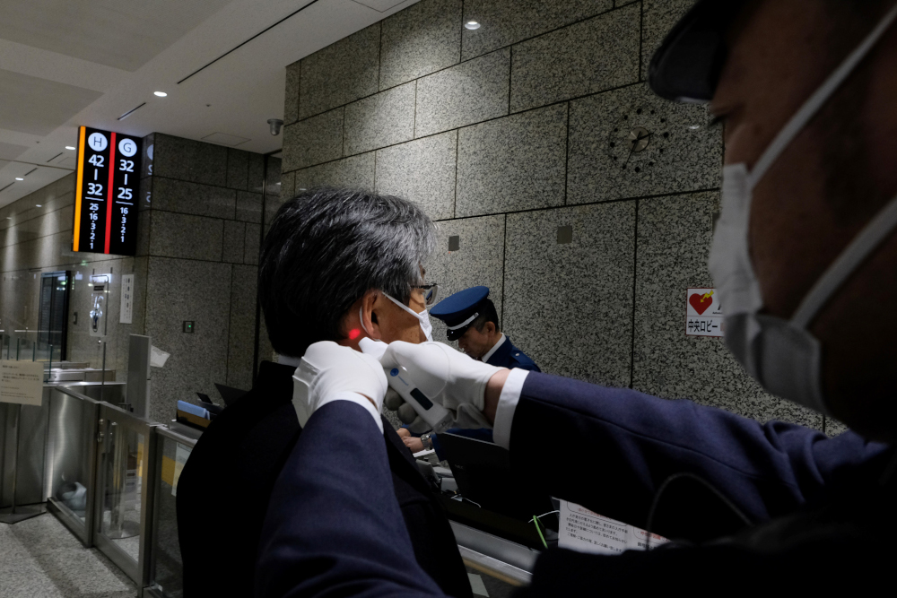 A security guard at the Tokyo Metropolitan Government office checks the body temperature of a visitor at the reception of the building in Tokyo March 5, 2020. u00e2u20acu201d AFP pic 