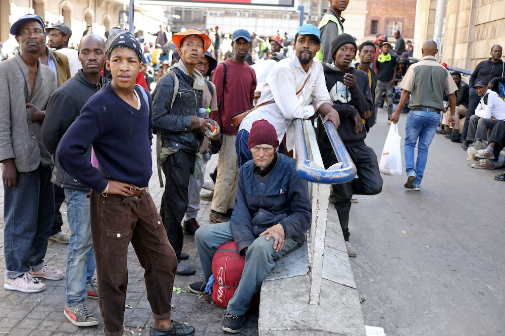 Homeless men look on during the first day of a nationwide lockdown for 21 days to try to contain the coronavirus disease (Covid-19) outbreak, in Johannesburg, South Africa, March 27, 2020. u00e2u20acu201d Reuters picnn