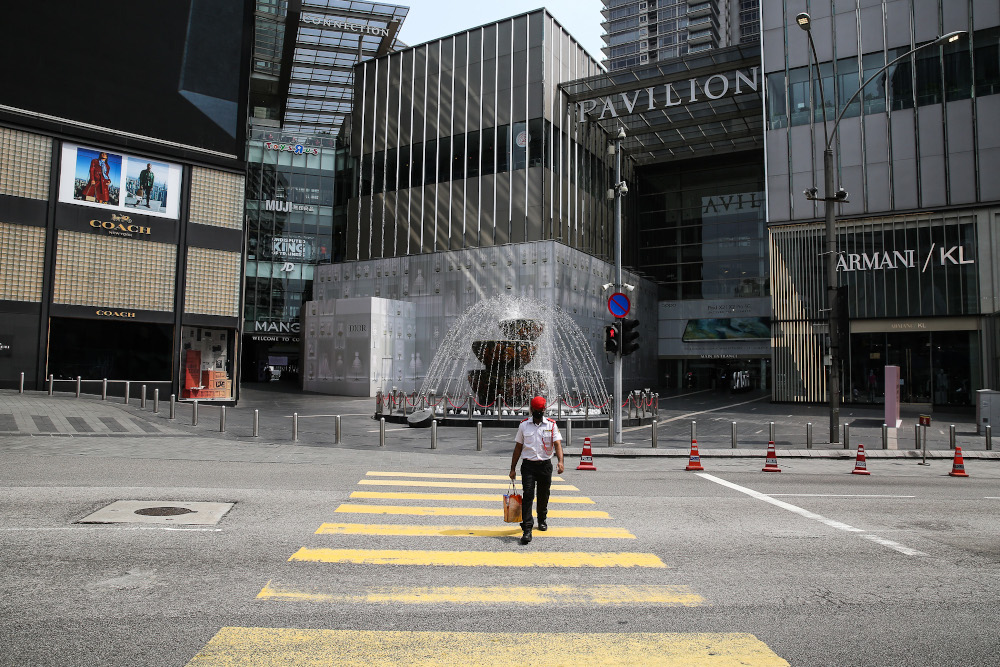 A security guard crosses the road in front of Pavilion in Kuala Lumpur March 21, 2020. u00e2u20acu201d Picture by Yusof Mat Isa