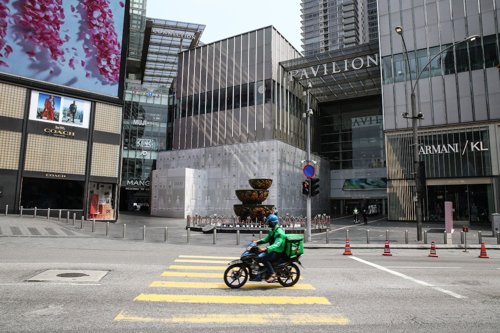 A food delivery rider rides past Pavilion in Kuala Lumpur March 21, 2020. u00e2u20acu201d Picture by Yusof Mat Isa