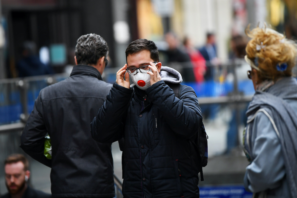 A man wears a mask as he walks through Knightsbridge, as the number of coronavirus cases grow around the world, in central London, Britain March 14, 2020. u00e2u20acu201d Reuters picnnn