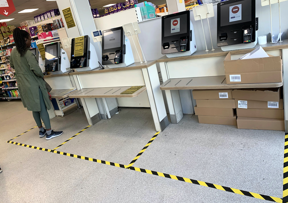A customer stands in a taped off check-out area designed to separate shoppers in a supermarket, as the spread of coronavirus disease (Covid-19) increases, in London, Britain, March 21, 2020. u00e2u20acu201d Reuters picnnn
