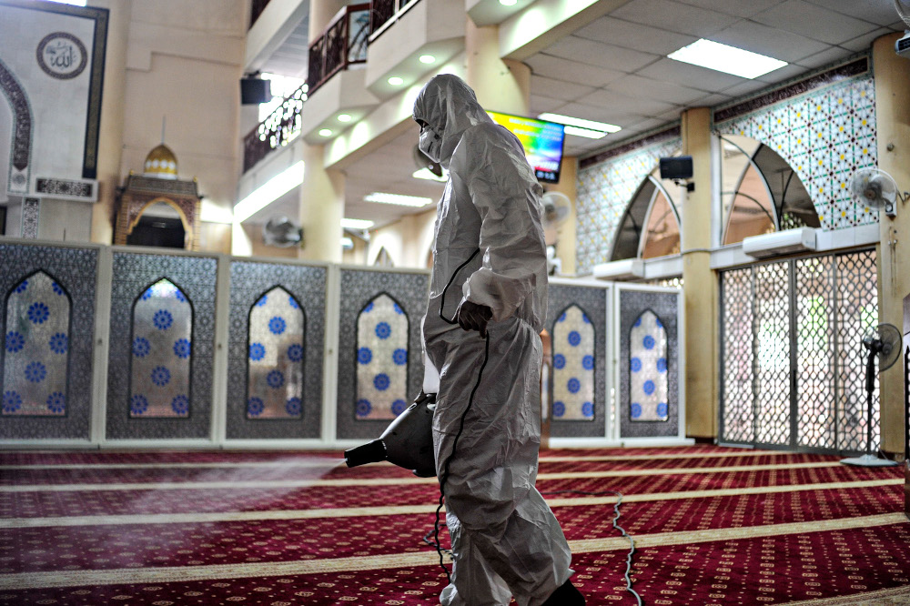 A worker sprays disinfectant in a mosque to prevent the spread of the coronavirus in Kuala Lumpur, March 21, 2020. u00e2u20acu201d Picture by Shafwan Zaidon