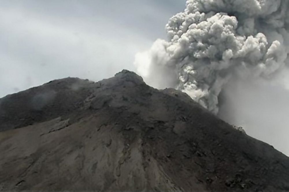 This handout picture taken and released on March 27, 2020 by Indonesiau00e2u20acu2122s disaster mitigation agency (BNPB) shows  volcano spewing thick volcanic ash as seen from Yogyakarta. u00e2u20acu201d Handout / BNPB / AFP pic