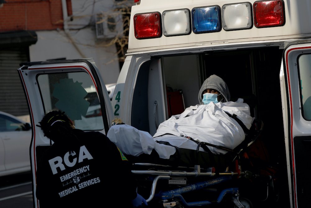 EMT’s load a patient into an ambulance as health workers continued to test people for coronavirus disease (Covid-19) outside the Brooklyn Hospital Centre in Brooklyn, New York City, US, March 27, 2020.
