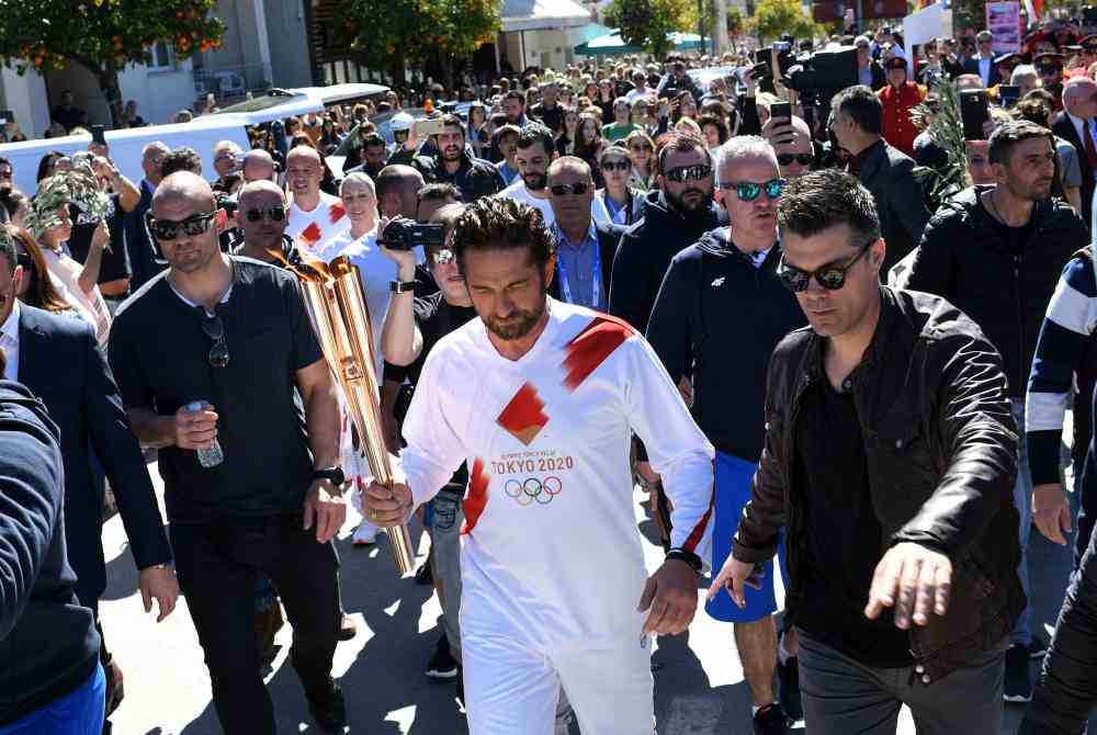 US actor Gerard Butler takes part in the Olympic flame torch relay for the Tokyo 2020 Summer Olympics in Sparta March 13, 2020. u00e2u20acu2022 Reuters pic